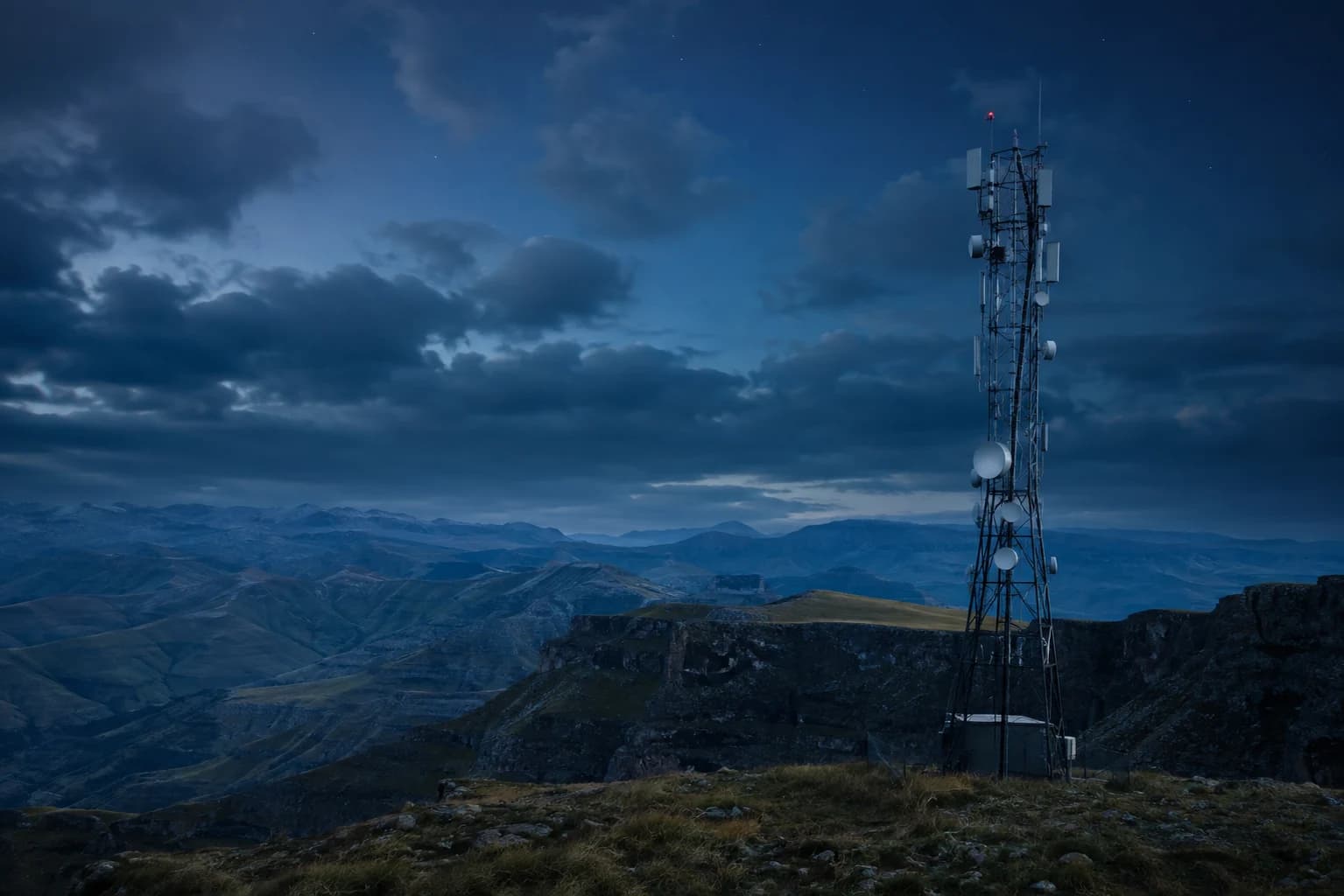 Telecommunications tower overlooking a mountainous landscape